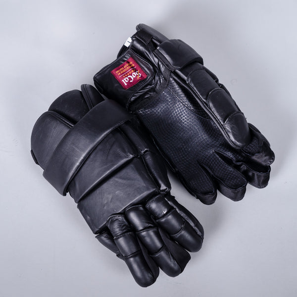 Padded lacrosse style gloves, left glove palm down right glove palm up on grey background